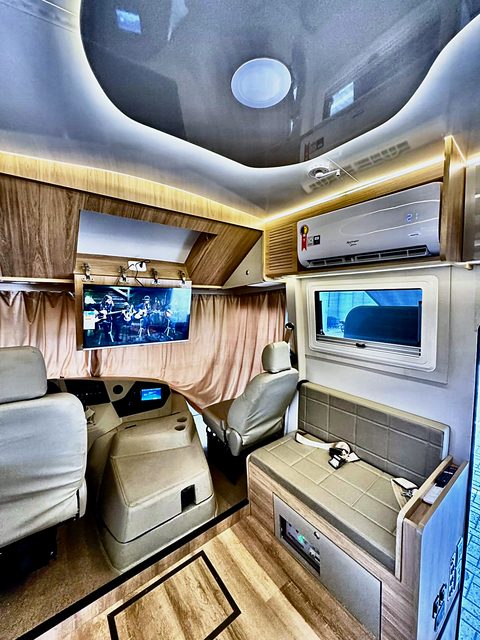 Cabine dianteira com bancos em couro e TV